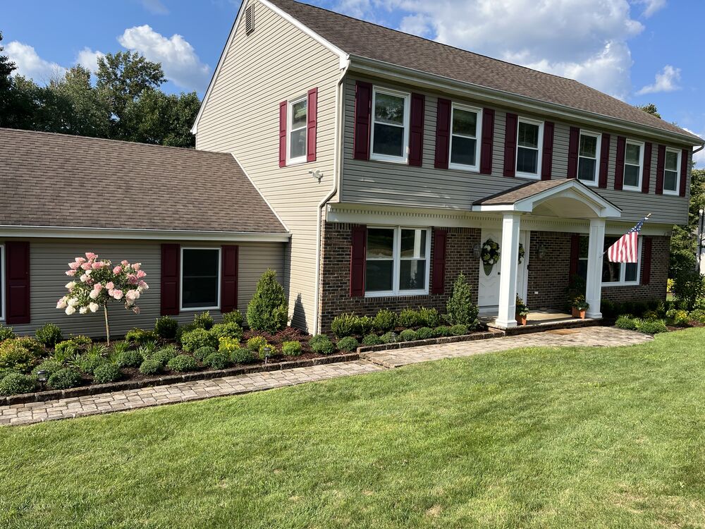 Foundation planting bed with ornamental tree and manicured lawn